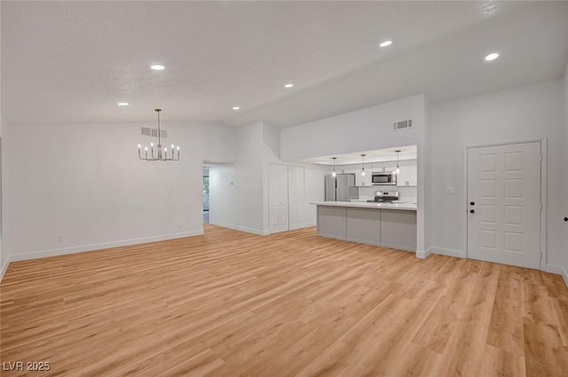 8412 Mulcahy Ave, Las Vegas, NV 89145 - unfurnished living room with a chandelier, light wood-style floors, vaulted ceiling, recessed lighting, and baseboards