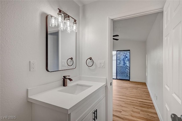 8412 Mulcahy Ave, Las Vegas, NV 89145 - bathroom with wood finished floors, lofted ceiling, vanity, and baseboards