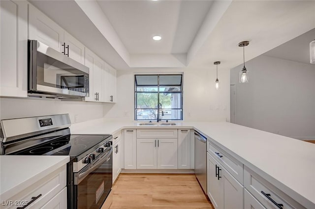 8412 Mulcahy Ave, Las Vegas, NV 89145 - kitchen featuring appliances with stainless steel finishes, a sink, light wood-style flooring, white cabinetry, and recessed lighting
