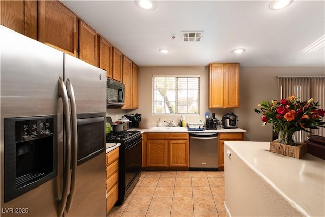3120 Inlet Bay Ave, North Las Vegas, NV 89031 - kitchen with black appliances, light countertops, a sink, recessed lighting, and light tile patterned flooring