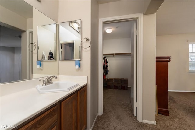 3120 Inlet Bay Ave, North Las Vegas, NV 89031 - bathroom featuring vanity, baseboards, and a spacious closet