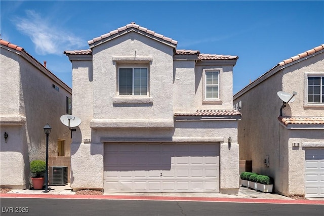 3120 Inlet Bay Ave, North Las Vegas, NV 89031 - mediterranean / spanish house with a tiled roof, a garage, and stucco siding