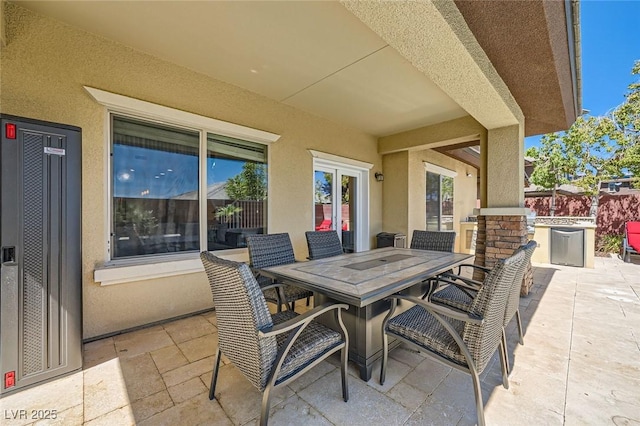view of patio / terrace featuring outdoor dining space and fence