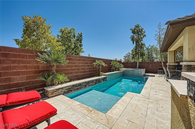 view of swimming pool with a fenced backyard, a patio, and a pool with connected hot tub