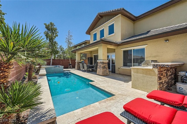 view of pool featuring exterior kitchen, an in-ground hot tub, a patio, and a fenced backyard