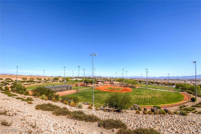 view of community with a mountain view and a yard