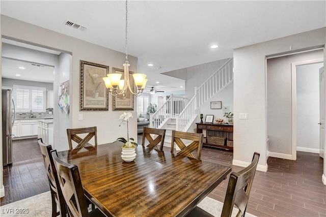dining space with dark wood-style floors, stairway, a chandelier, baseboards, and recessed lighting