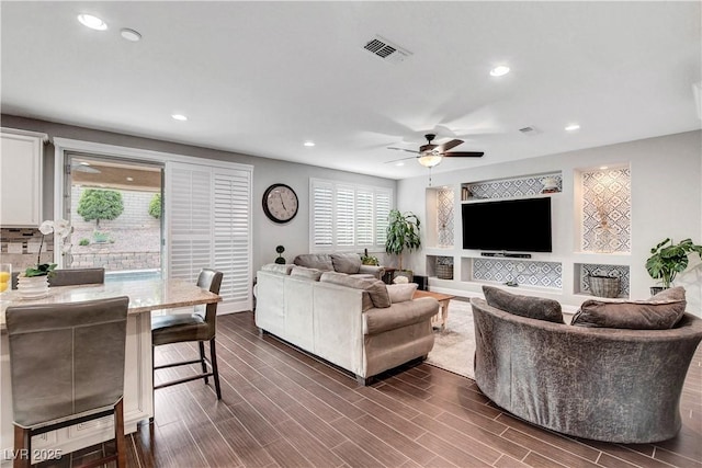 living room with ceiling fan, recessed lighting, and dark wood finished floors