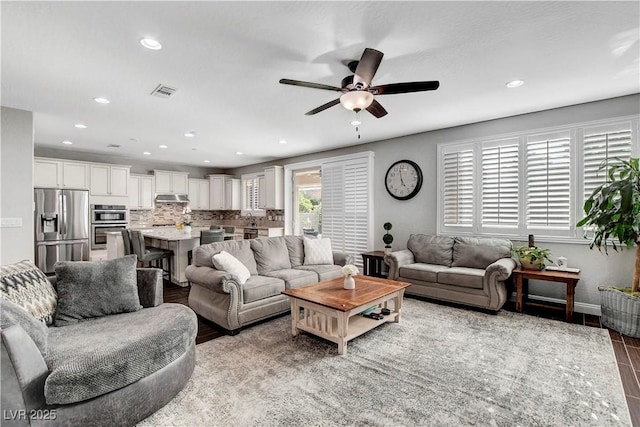 living room featuring recessed lighting, ceiling fan, wood finished floors, and baseboards