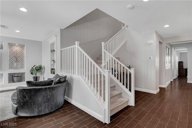 staircase featuring baseboards, wood finished floors, recessed lighting, and built in features