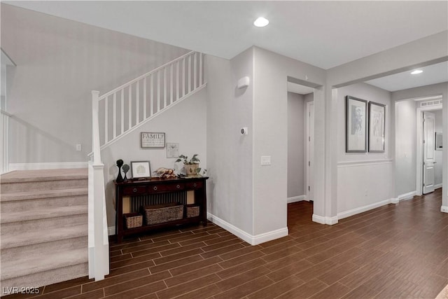 entryway with dark wood-style floors, stairway, baseboards, and recessed lighting