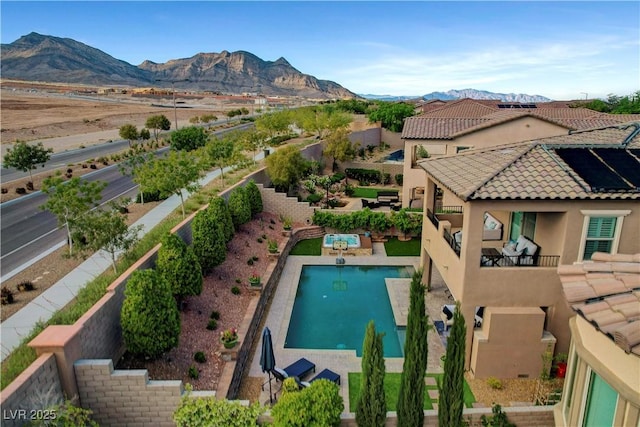 view of pool with a mountain view, a patio, and a fenced backyard
