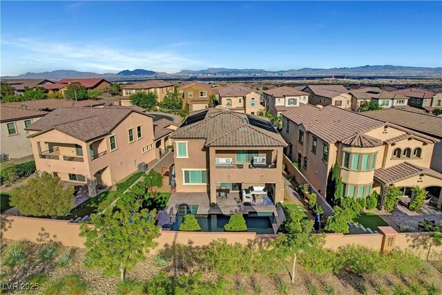 aerial view of residential area featuring a mountainous background