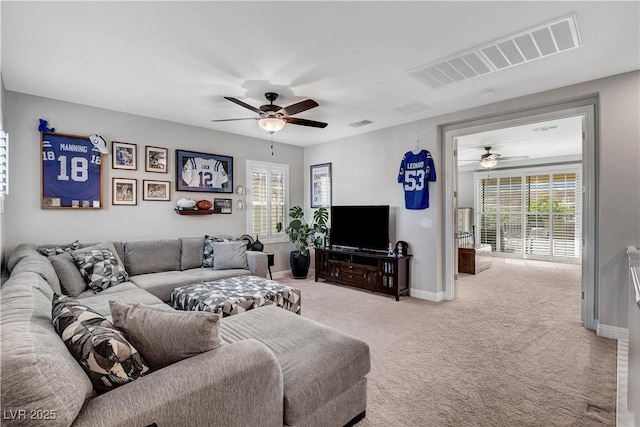 living area featuring a ceiling fan, carpet, and baseboards