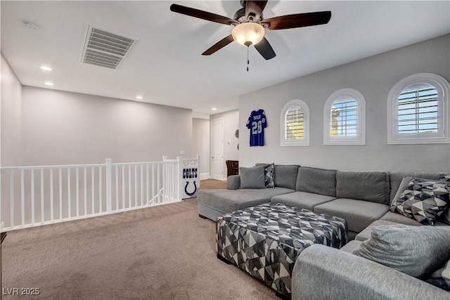 carpeted living room with a ceiling fan and recessed lighting