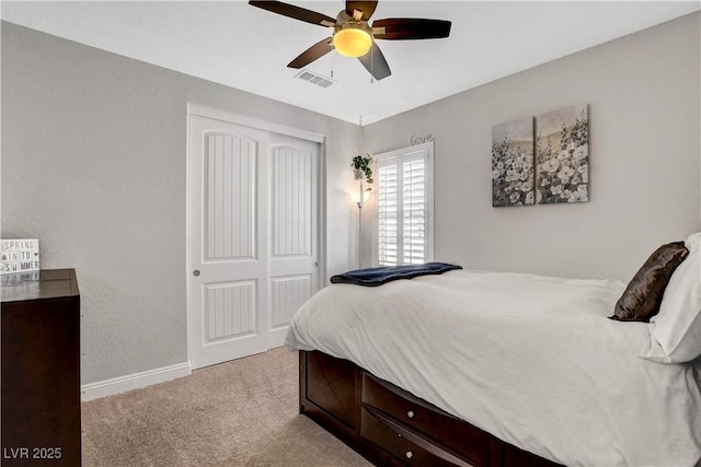 bedroom featuring carpet flooring, a closet, baseboards, and ceiling fan