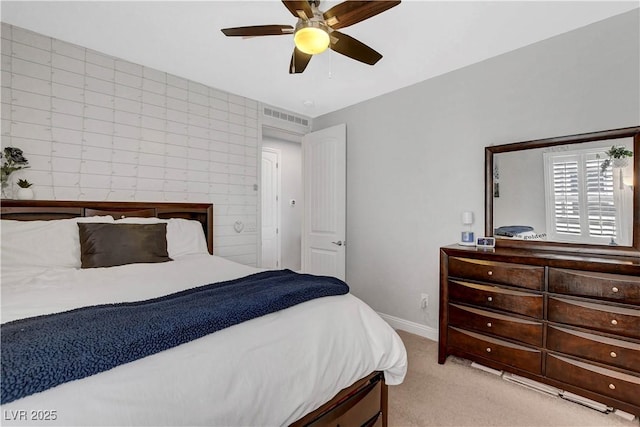 bedroom featuring light colored carpet, baseboards, and ceiling fan
