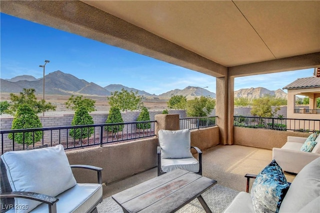 balcony featuring a mountain view and an outdoor hangout area