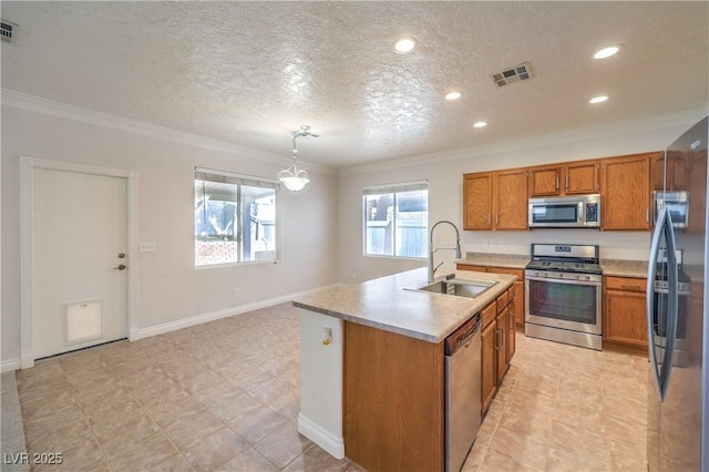 kitchen featuring stainless steel appliances, a sink, crown molding, brown cabinetry, and light countertops