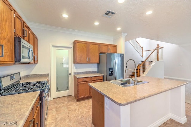 kitchen featuring appliances with stainless steel finishes, a sink, crown molding, brown cabinetry, and recessed lighting