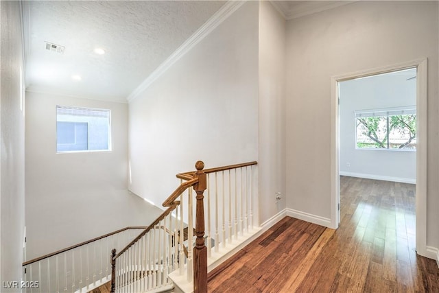 hall featuring an upstairs landing, wood finished floors, crown molding, recessed lighting, and baseboards