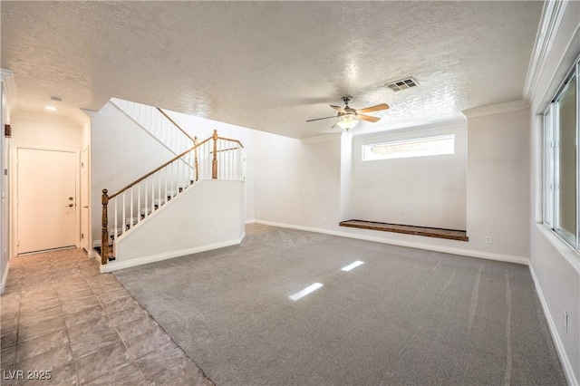 unfurnished living room featuring a textured ceiling, a ceiling fan, crown molding, stairs, and baseboards