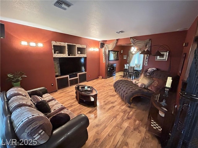 living room with wood finished floors and a textured ceiling