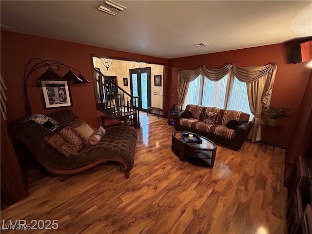 living room featuring wood finished floors and stairs