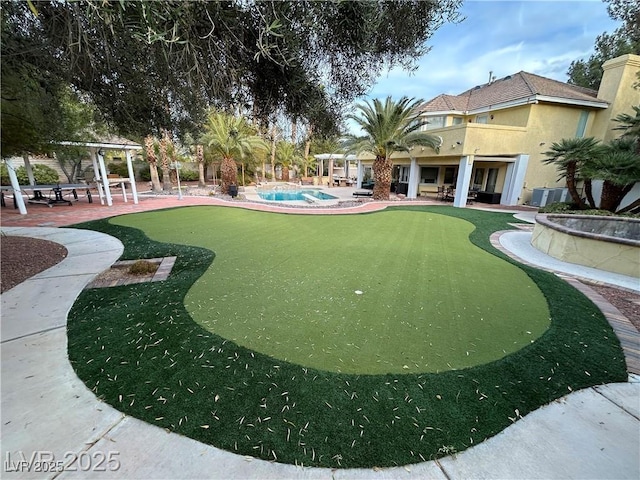 surrounding community featuring a putting area, a patio area, and a swimming pool