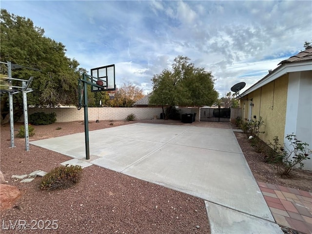 view of sport court featuring a fenced backyard and basketball court