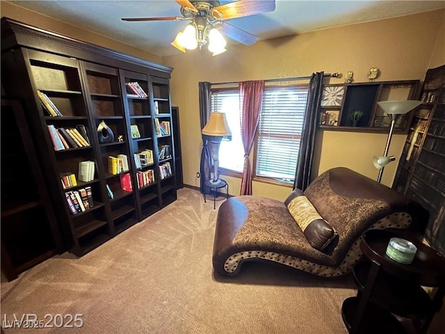 sitting room with carpet floors and a ceiling fan
