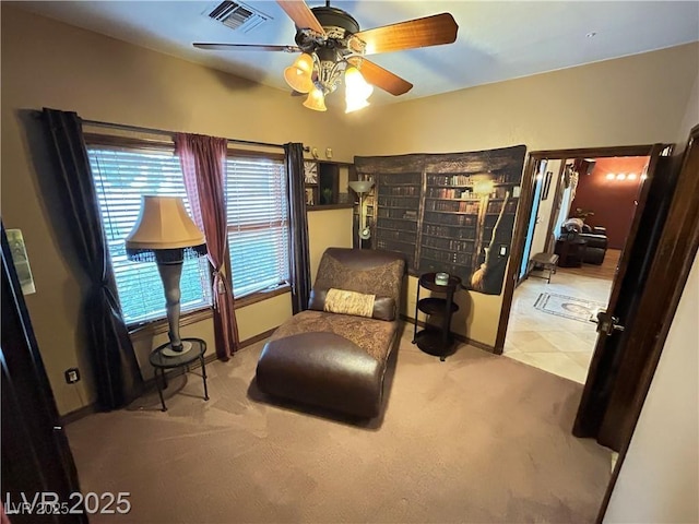 sitting room with carpet and a ceiling fan