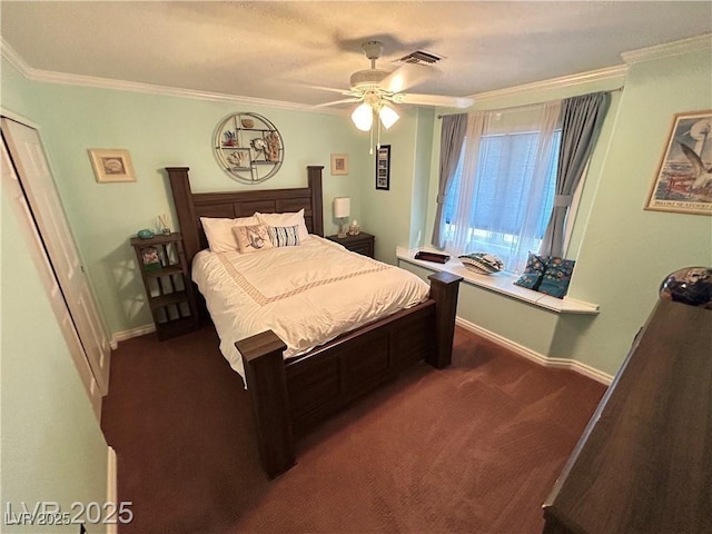 bedroom featuring dark colored carpet, crown molding, baseboards, and ceiling fan