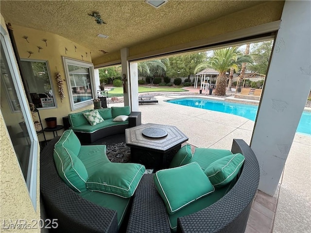 swimming pool with a patio area, outdoor lounge area, and a gazebo