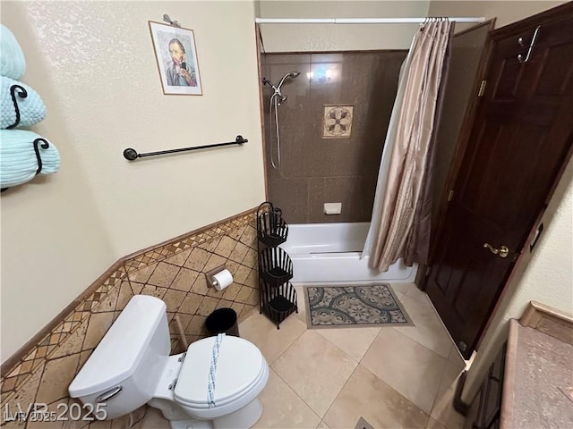 full bathroom featuring toilet, tile patterned floors, and shower / bath combo with shower curtain