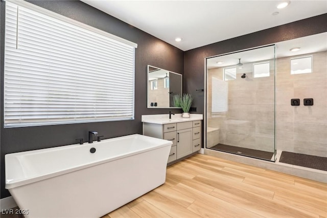 12155 Sage Thunder Ave, Las Vegas, NV 89138 - bathroom with vanity, a tile shower, a soaking tub, wood finished floors, and recessed lighting