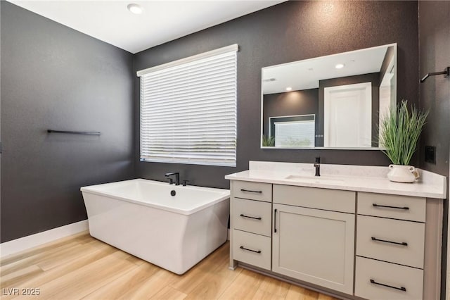 12155 Sage Thunder Ave, Las Vegas, NV 89138 - full bath featuring vanity, a freestanding bath, and wood finished floors