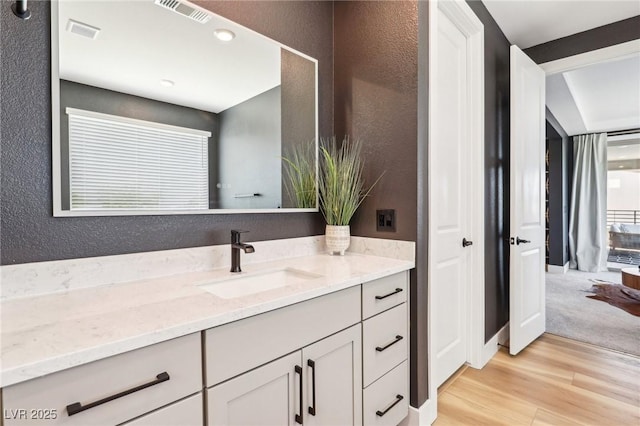 12155 Sage Thunder Ave, Las Vegas, NV 89138 - bathroom featuring vanity, wood finished floors, and a textured wall