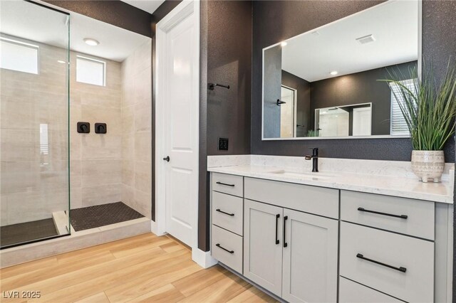 12155 Sage Thunder Ave, Las Vegas, NV 89138 - bathroom with vanity, wood finished floors, and a tile shower