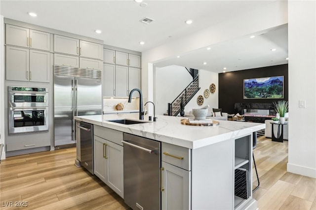 12155 Sage Thunder Ave, Las Vegas, NV 89138 - kitchen featuring gray cabinets, appliances with stainless steel finishes, a sink, light wood finished floors, and recessed lighting
