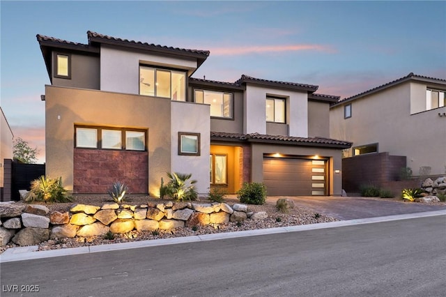 12155 Sage Thunder Ave, Las Vegas, NV 89138 - view of front facade featuring stucco siding, driveway, a tiled roof, and a garage