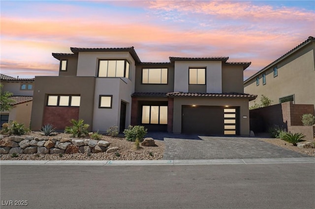 12155 Sage Thunder Ave, Las Vegas, NV 89138 - view of front of property with stucco siding, a garage, a tiled roof, and decorative driveway