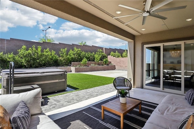 12155 Sage Thunder Ave, Las Vegas, NV 89138 - fenced backyard featuring a hot tub, outdoor lounge area, a patio area, and a ceiling fan