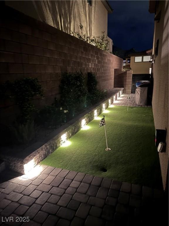 12155 Sage Thunder Ave, Las Vegas, NV 89138 - yard at twilight featuring an area to practice putting