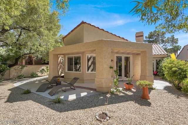 5142 Southern Hills Ln, Las Vegas, NV 89113 - back of property featuring stucco siding, a chimney, a patio, and a tile roof