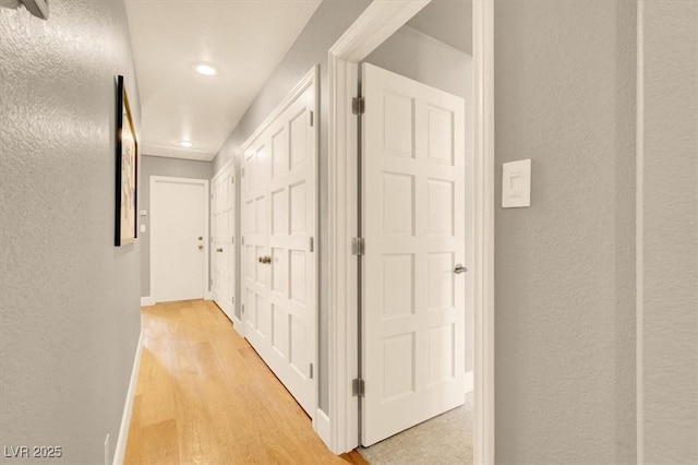 5142 Southern Hills Ln, Las Vegas, NV 89113 - hallway with light wood-style flooring, recessed lighting, and a textured wall