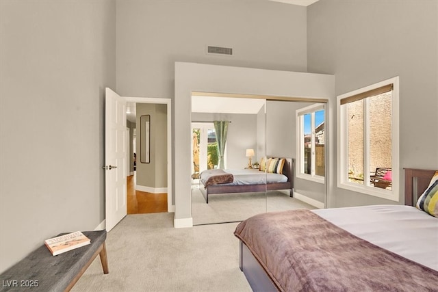 5142 Southern Hills Ln, Las Vegas, NV 89113 - bedroom featuring a towering ceiling, carpet, a closet, and baseboards