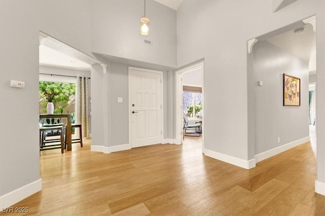 5142 Southern Hills Ln, Las Vegas, NV 89113 - entrance foyer featuring plenty of natural light, light wood-style flooring, baseboards, and a towering ceiling