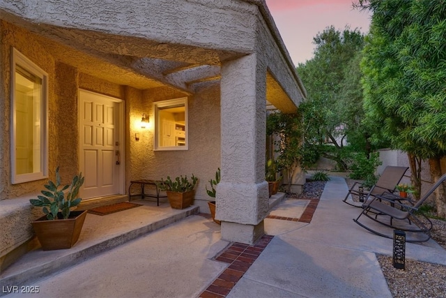 5142 Southern Hills Ln, Las Vegas, NV 89113 - exterior entry at dusk featuring stucco siding