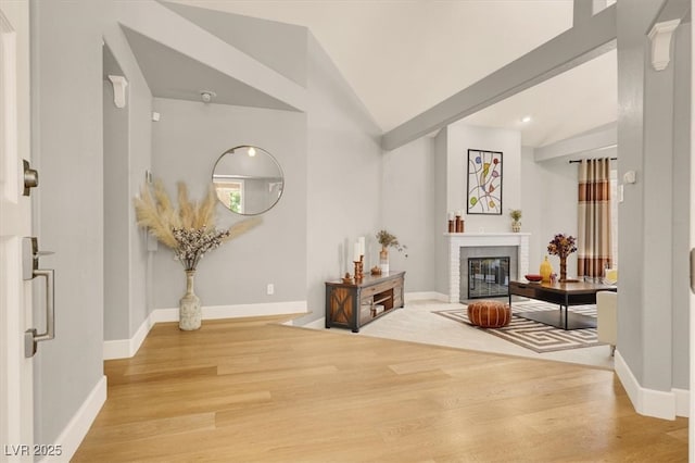 5142 Southern Hills Ln, Las Vegas, NV 89113 - living area with wood finished floors, lofted ceiling, and baseboards